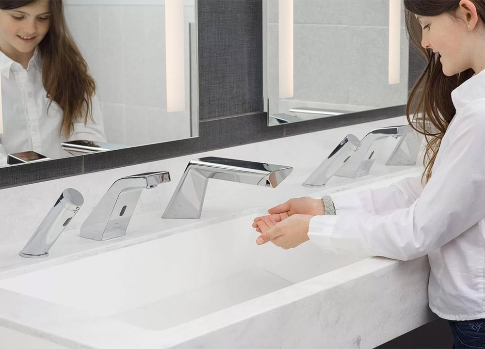 Girl using solid surface touchless wash trough and dryer